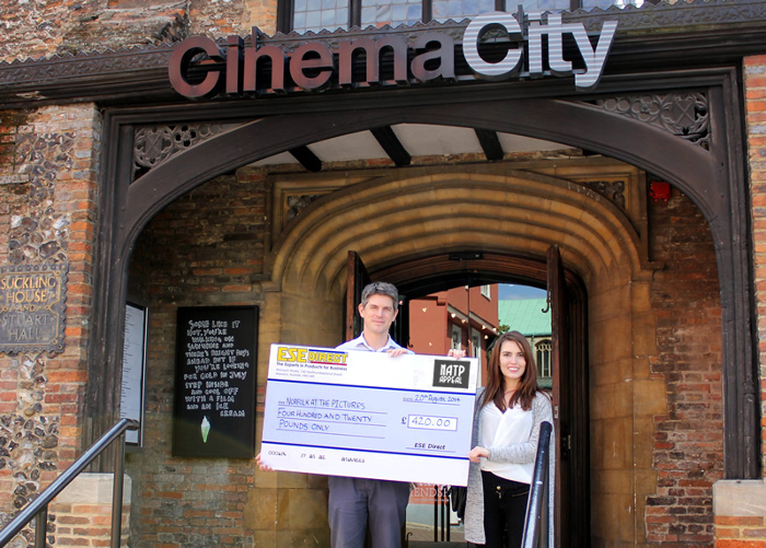 Laura Holland present the cheque to Marc Atkinson at Cinema City, Norwich