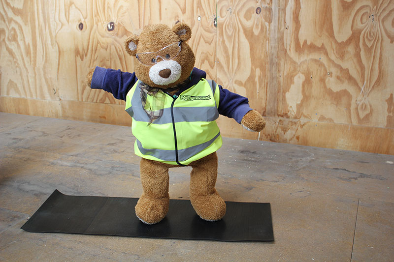 Health and Safety Bear demonstrates Warrior 2 Yoga Pose