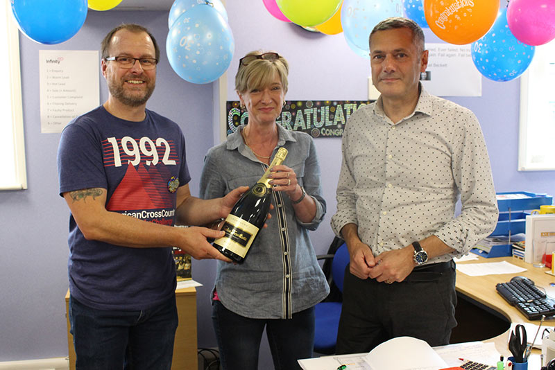 Managing Director, Jackie Wells presents Stuey with a rather large bottle of Champagne!