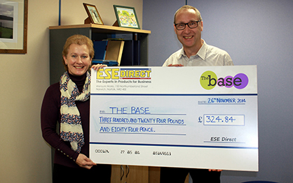 Karen Howes on behalf of The Base, accepts the cheque from Mike Wyard