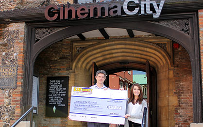 Mark Atkinson receives the cheque on behalf of Norfolk at the Pictures