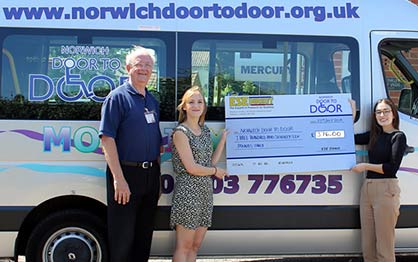 Norwich Door to Door receive their cheque from Laura