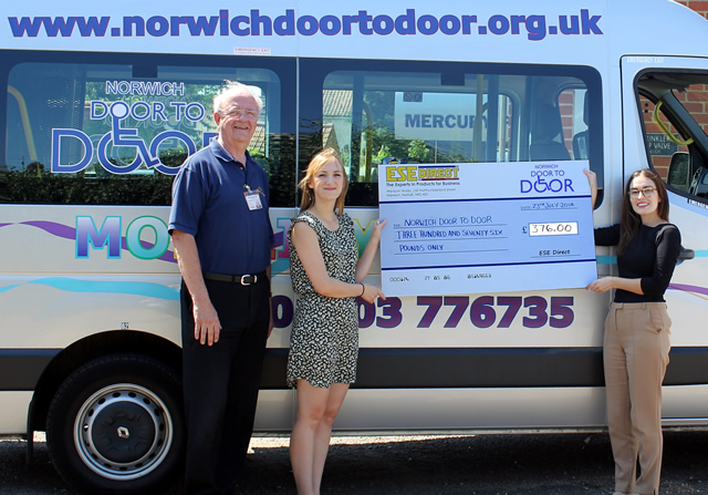 Laura Holland presents the cheque to Norwich Door to Door