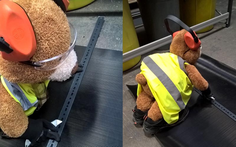 Health and Safety Bear carefully cutting the rubber matting