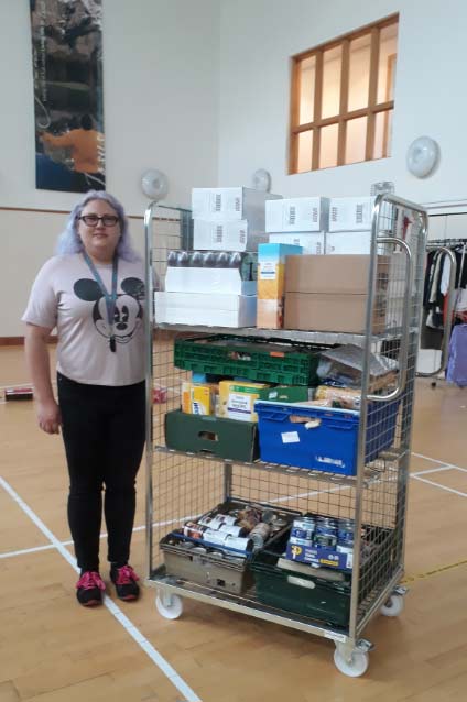 Community worker Rachel Baker with the merchandise picking trolley