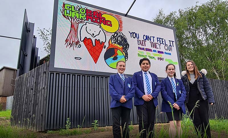 The winning climate change poster displayed on a billboard