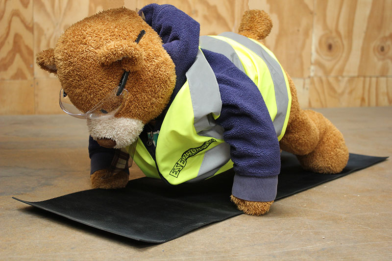 Health and Safety Bear demonstrates Downward Dog Yoga Pose