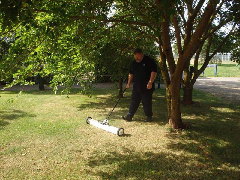 Kevin clears ferrous waste from the lawn