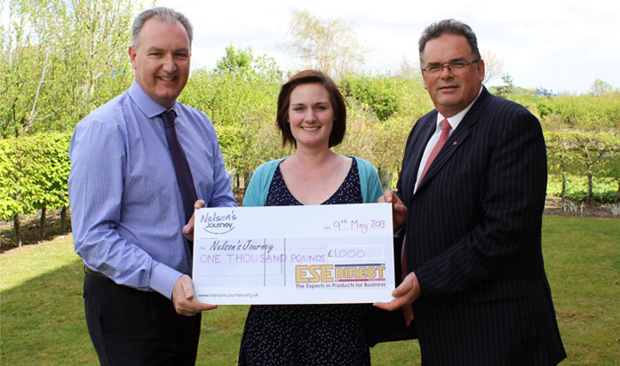 Simon Francis presents the cheque to Nelson's Journey