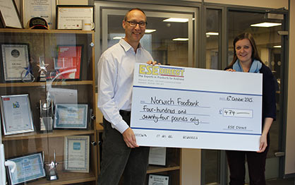 Mike Wyard from ESE Direct presents the cheque to Hannah Worsley, Project Manager of Norwich Foodbank