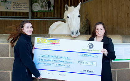 ESE's Laura presents the cheque to Katherine Green as India watches.